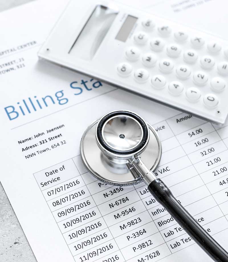 medical treatmant billing statement with stethoscope and calculator on stone background